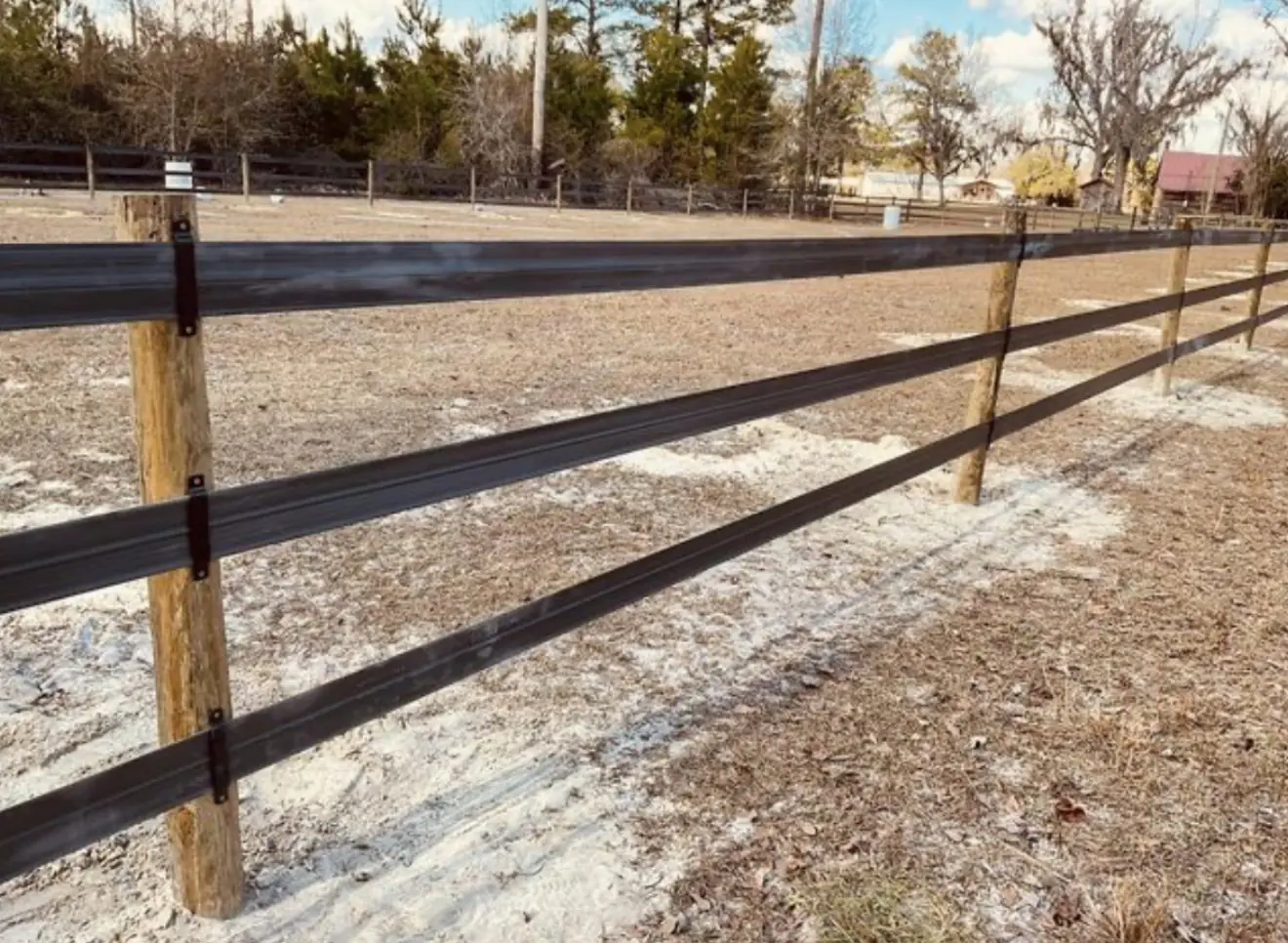 Black flex-rail horse fencing on wood posts