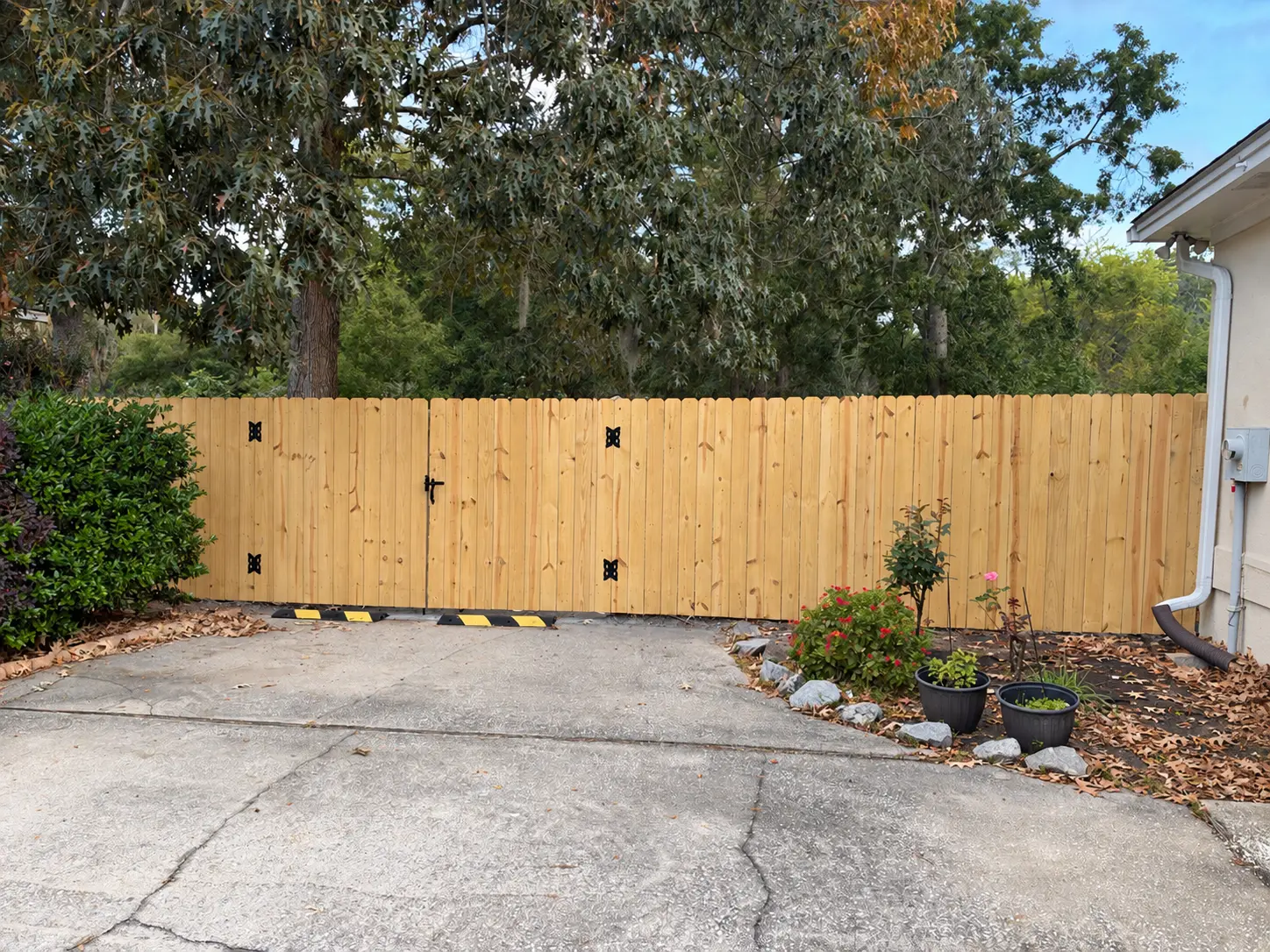 Front view of a 6ft wood privacy fence with double gate and black hardware installed by Owens Contracting in Strathy Hall, Richmond Hill, GA