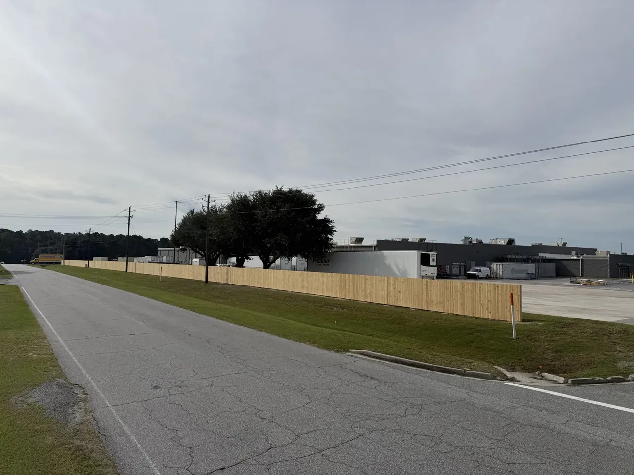 Roadside view of the replacement wood privacy fence at Walmart Rincon