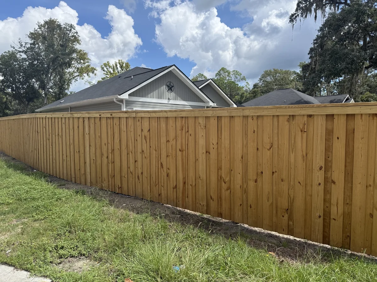 Board-on-board cap-and-trim fence in Walthourville